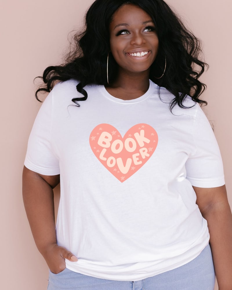 Front of a model wearing a size XL Book Lover Heart in White by Simply Sage Market. | dia_product_style_image_id:281423